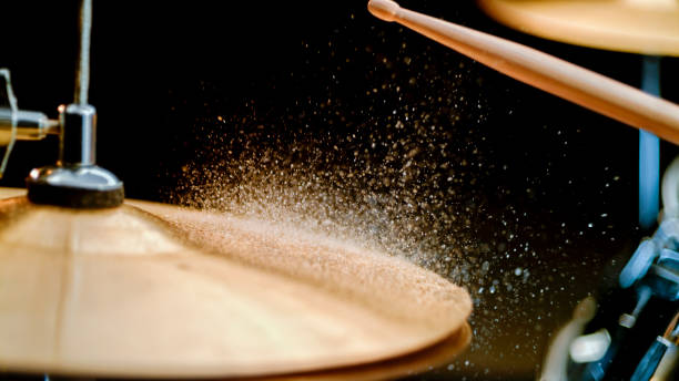 drumstick striking on wet cymbal.